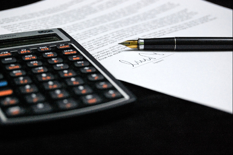 calculateor next to paperwork and pen