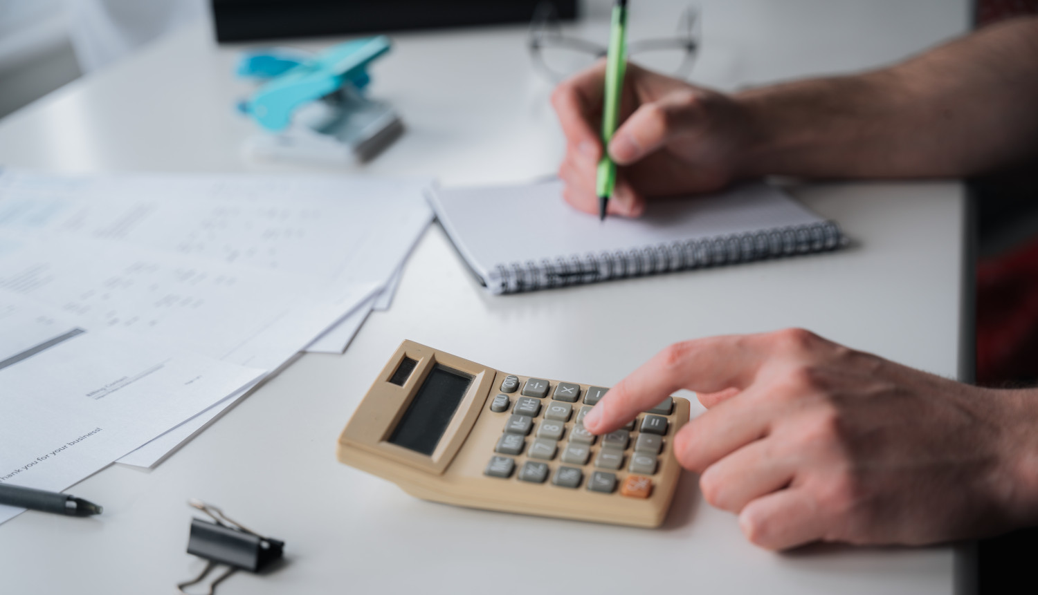 An image of an accountant calculating finances and balancing numbers.
